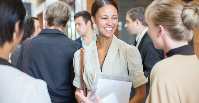 People talking in a group at a conference